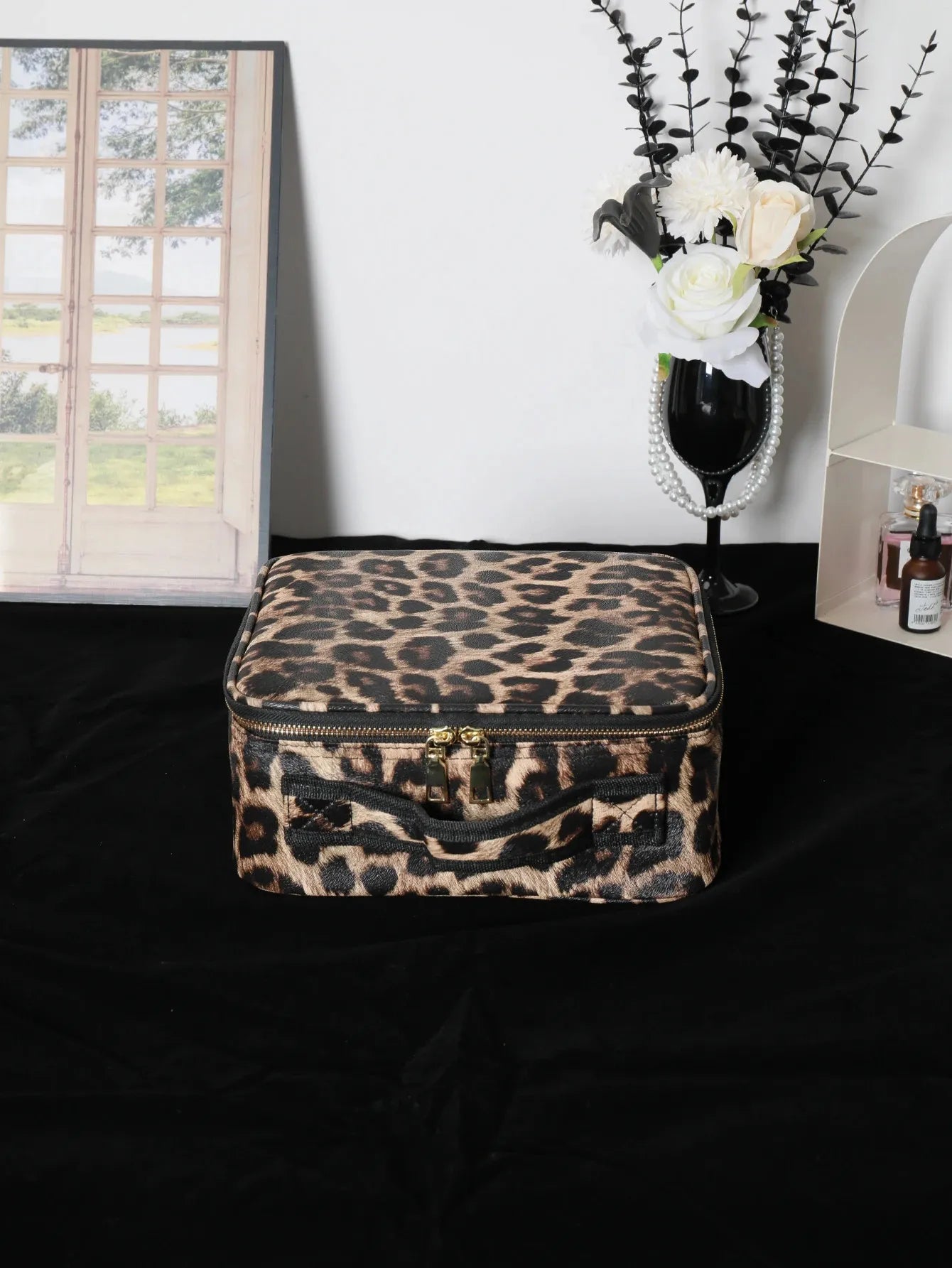 Makeup bag in use with cosmetics arranged inside showing storage capacity