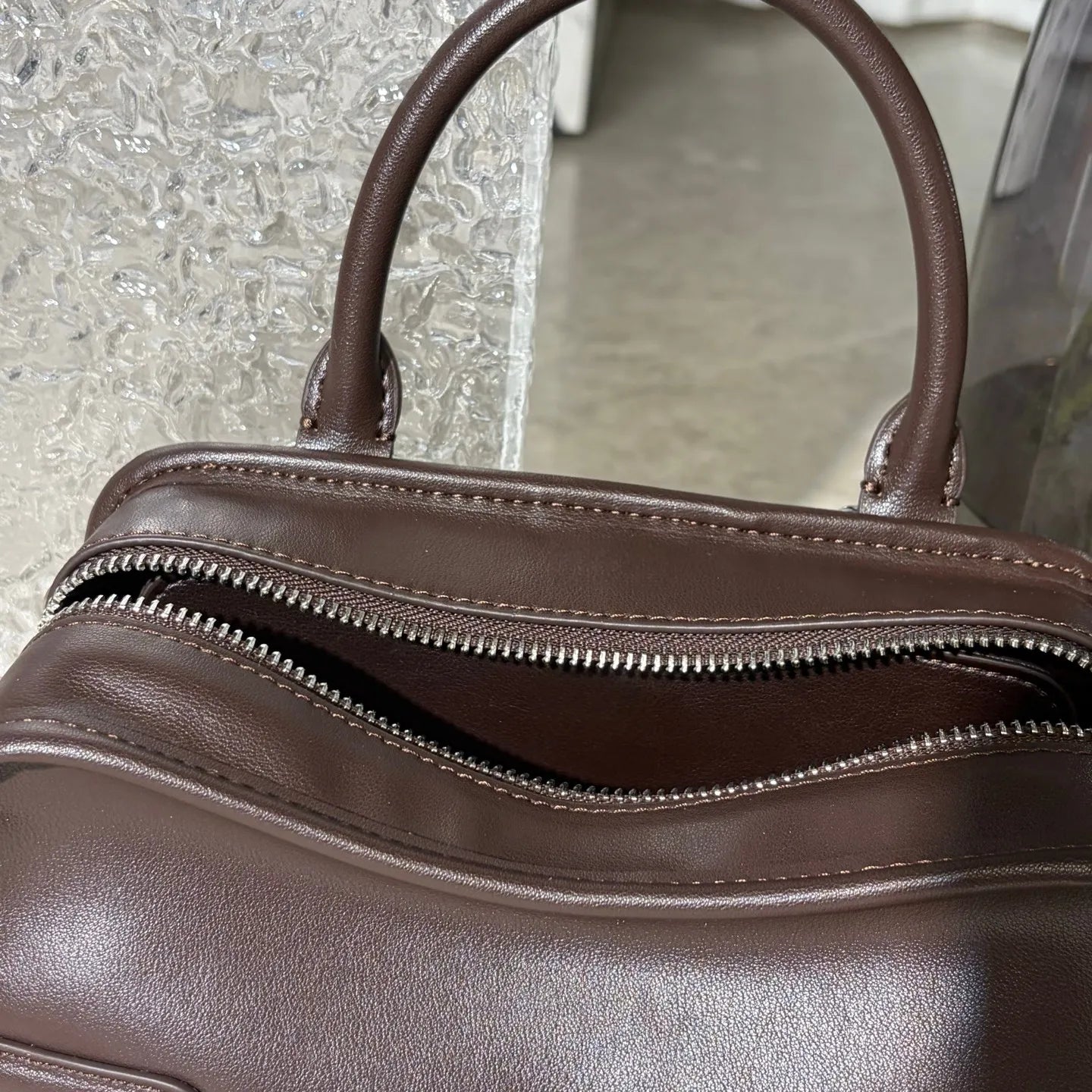 Side angle of the tote bag displaying compartments and size