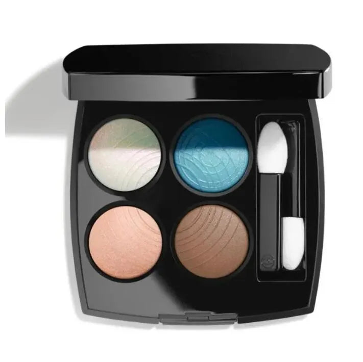 Four-color eyeshadow palette open with glitter and matte shades