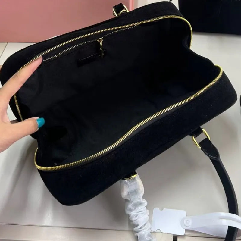 Side profile of the handbag demonstrating crossbody wear style