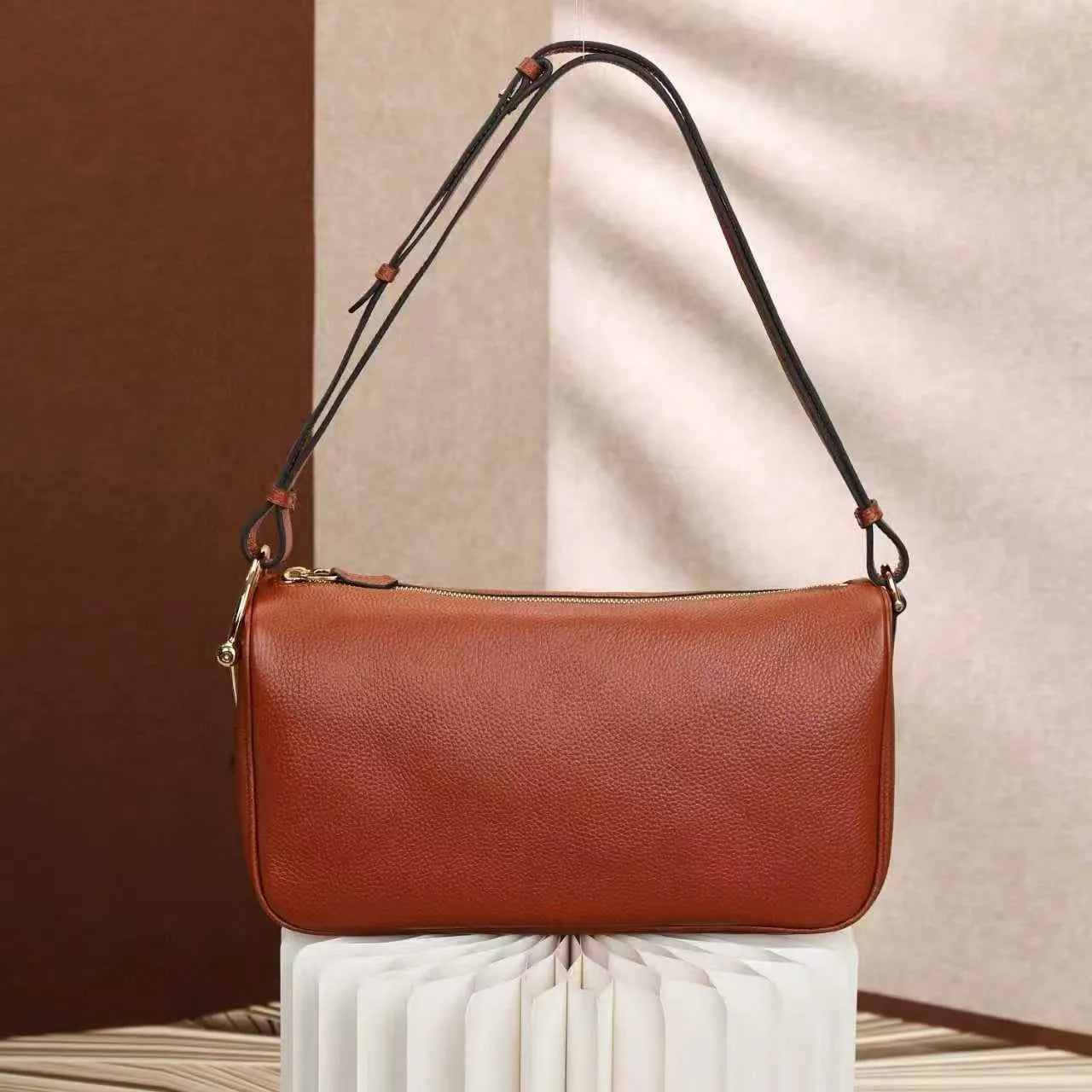 Front view of medium shoulder satchel bag showing structured design