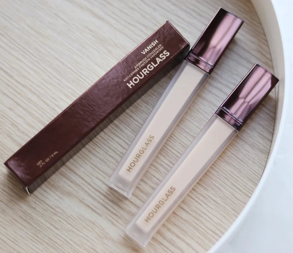 Liquid concealer stick in neutral packaging with applicator tip visible