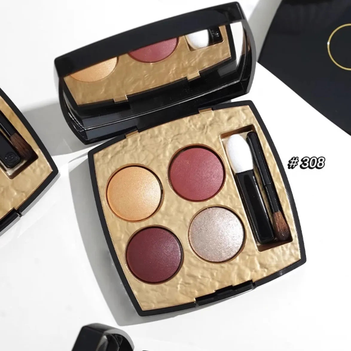 Four-color eyeshadow palette showing orange earth tone shades