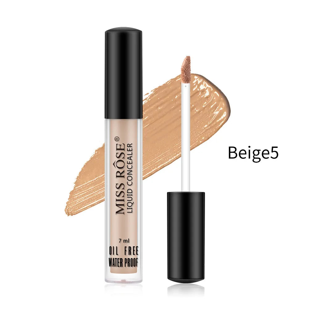 Hand holding concealer stick applying product to under-eye area