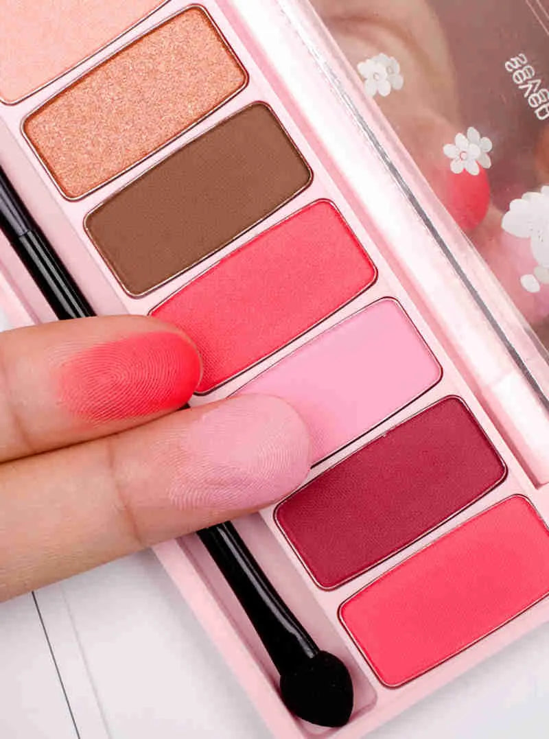 Close-up of red and pink glitter eyeshadow shades in palette