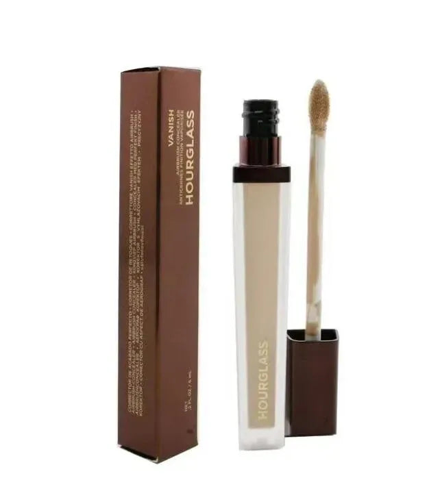 Makeup brush applying concealer to facial area
