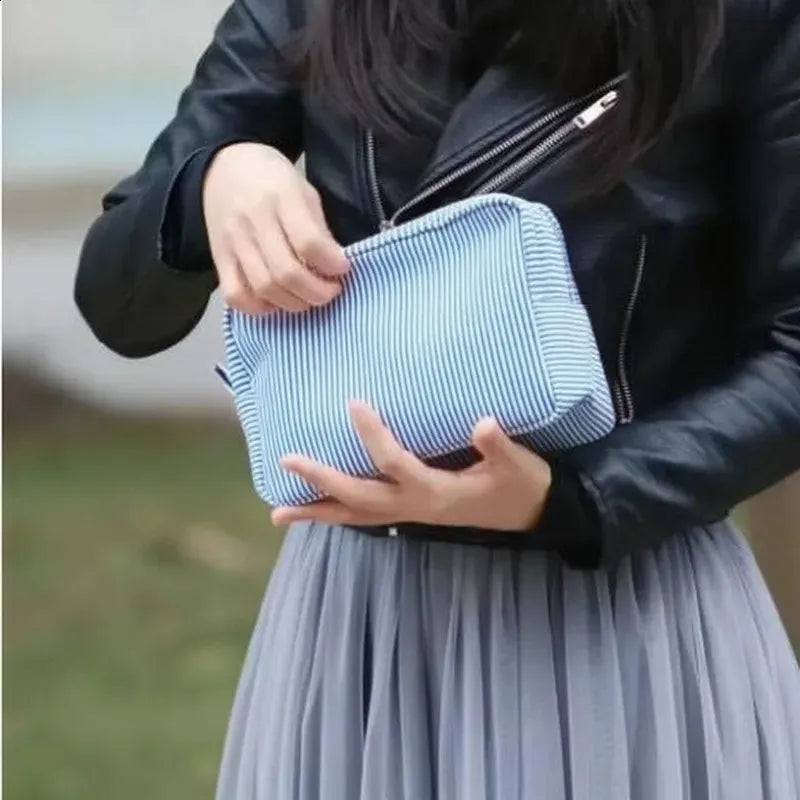 Seersucker cosmetic bag with ruffle detailing and pink purple stripes