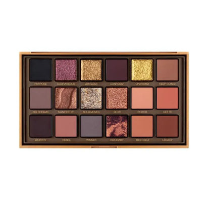 Eyeshadow palette in use with makeup brush applying shimmer shade