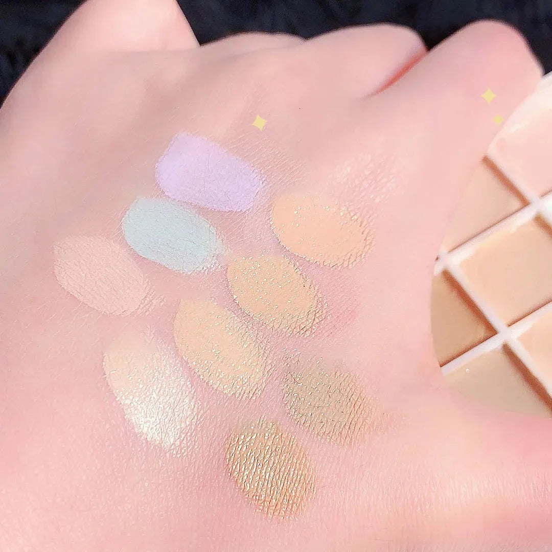 Close-up view of concealer shades being applied to skin with a makeup brush