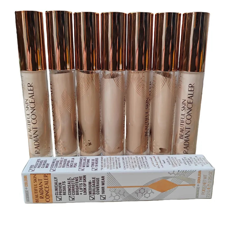 Liquid concealer in tube with doe-foot applicator on white background