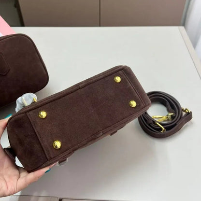 Side profile of the handbag demonstrating crossbody wear style