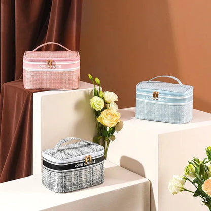 Open view showing multiple compartments inside the travel cosmetic organizer
