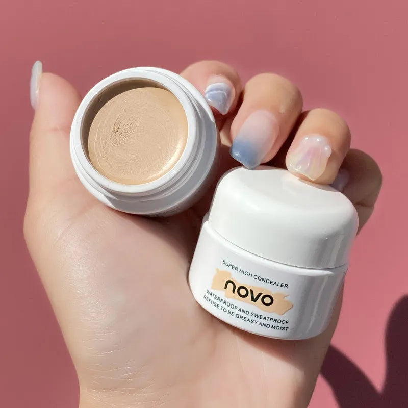 Close-up view of concealer being applied to skin with fingertip