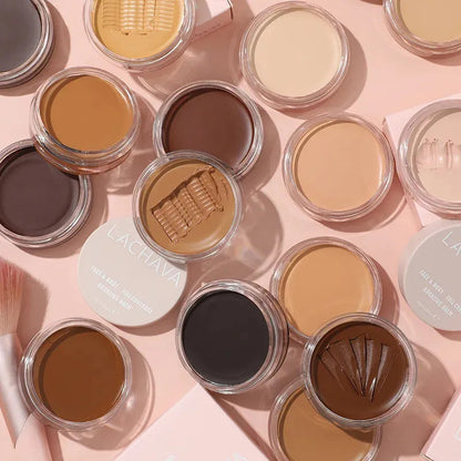 Open makeup palette showing multiple shades of concealer cream