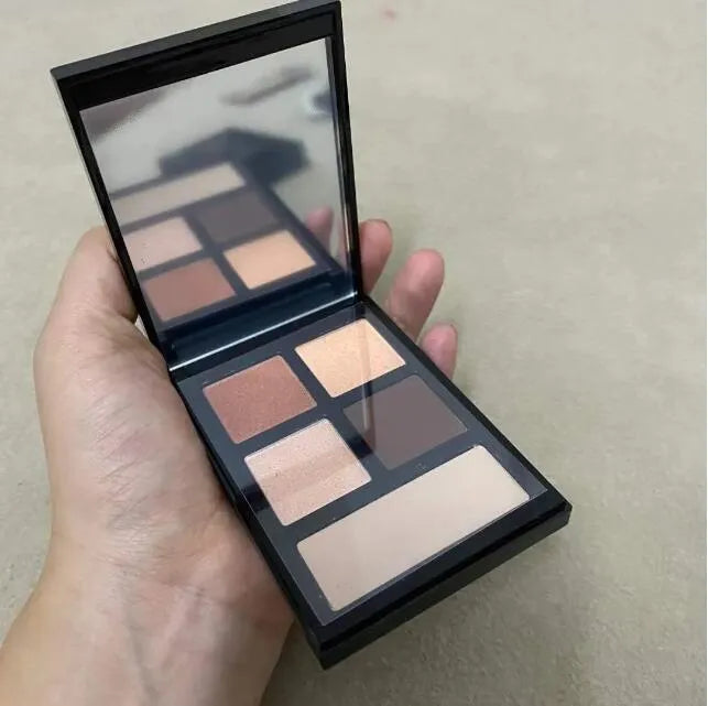 Eye shadow palette with five complementary shades open on white background
