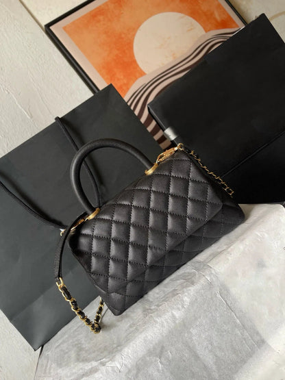 Front view of a women's leather crossbody bag with gold metal flap closure