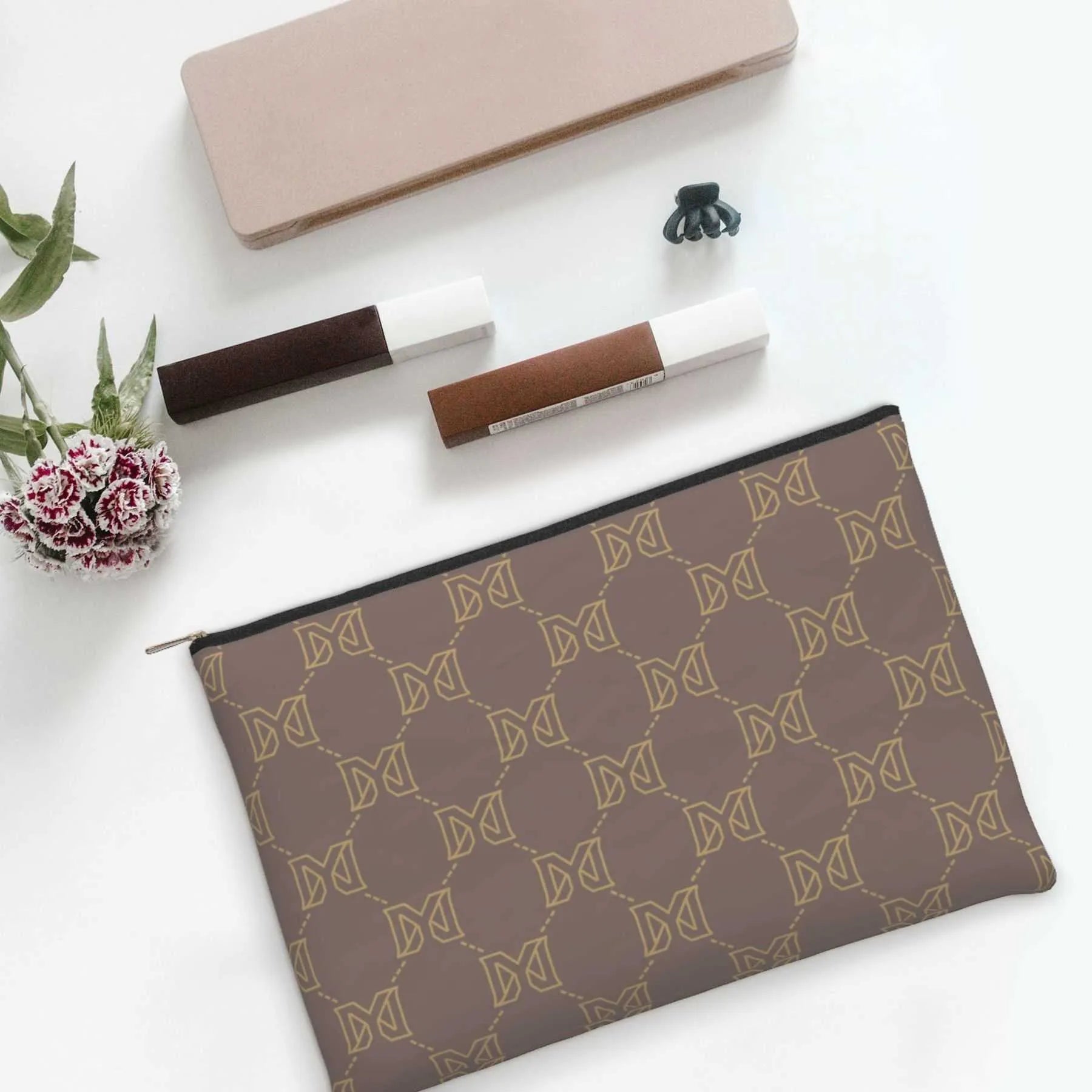 Cosmetic bag held in hand to display size and design
