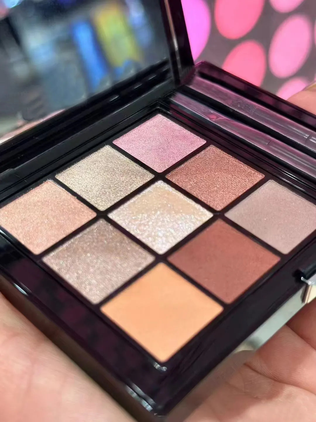 Nine-color eyeshadow palette showing shimmer and glitter finishes