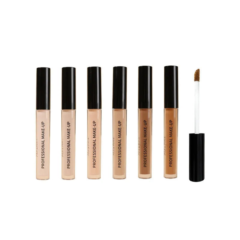 Close-up view of concealer being applied to skin with a brush applicator