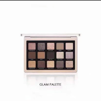 Eyeshadow palette open with mirror visible and shades labeled for color reference