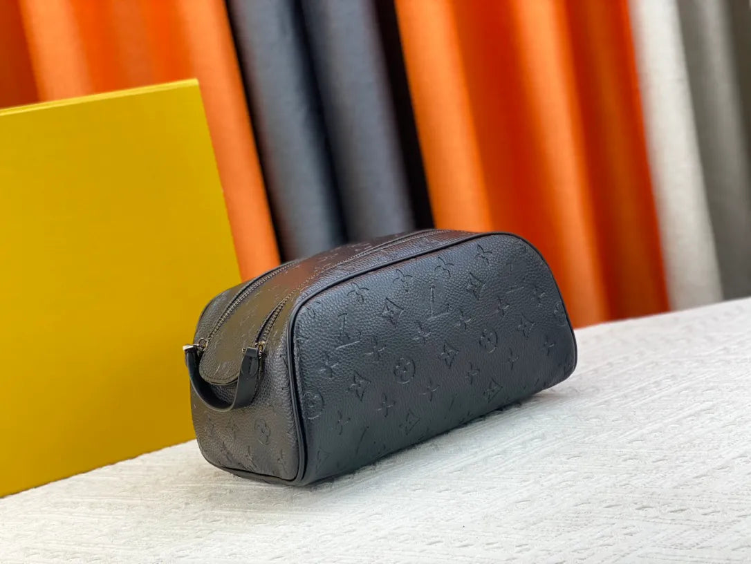Cosmetic bag placed next to makeup products for size reference