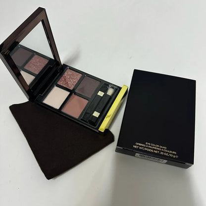 Eyeshadow palette open showing mirror and four color pans
