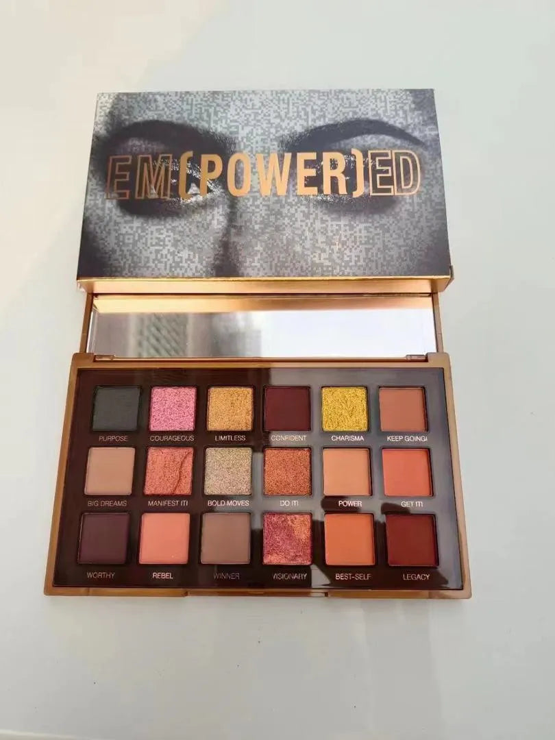 Close-up view of eyeshadow palette with color swatches on skin