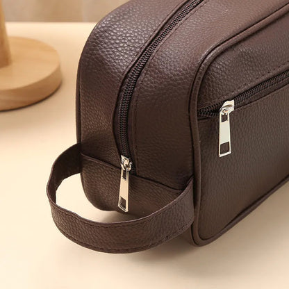 Toiletry bag displayed with travel accessories for size reference