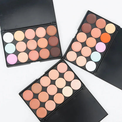 Open makeup palette showing multiple cream concealer shades arranged in rows