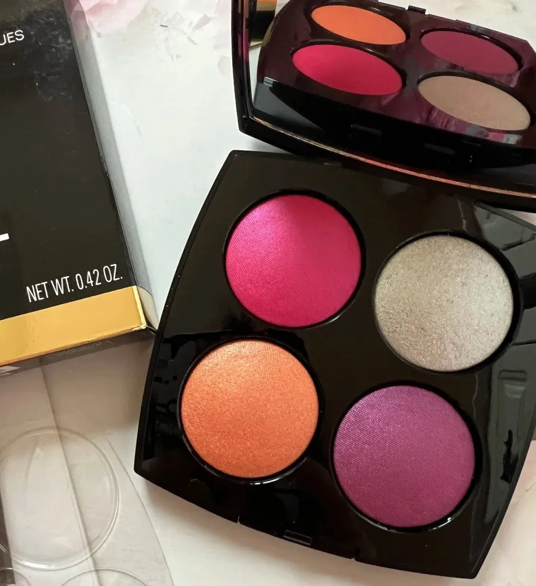 Eye shadow and blush palette with pearl light finish open on table