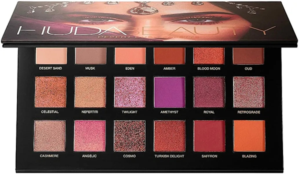 Close-up of eyeshadow palette with brush on side