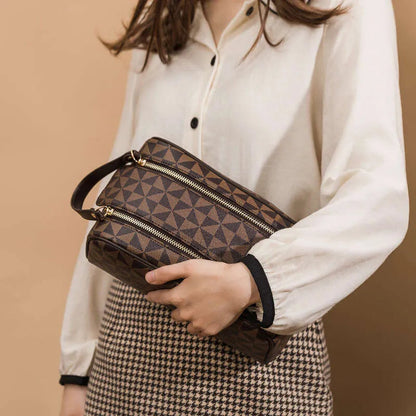 Handheld leather bag being carried with toiletry items visible inside