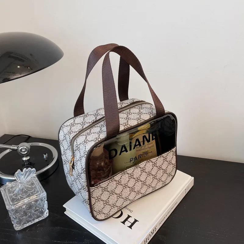 Waterproof toiletry bag with zippered closure open to show interior