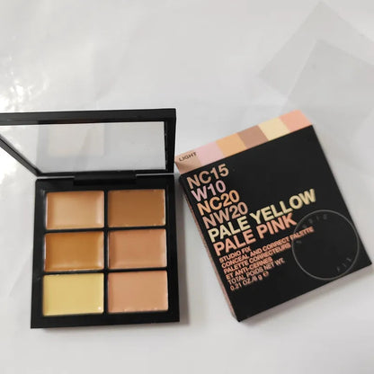 Open makeup palette showing six cream concealer shades arranged in two rows