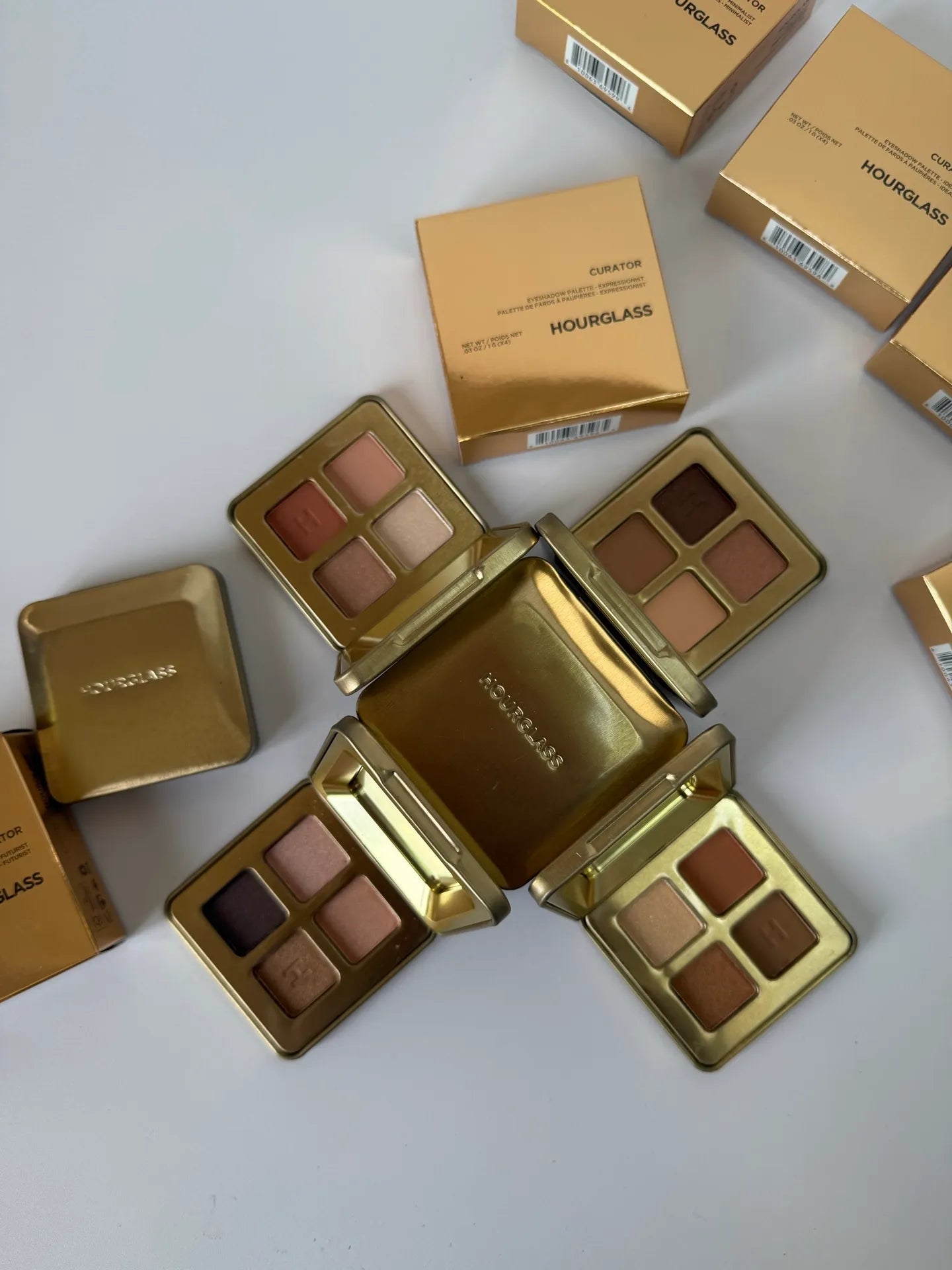 Eyeshadow palette open with four coordinated metallic shades displayed