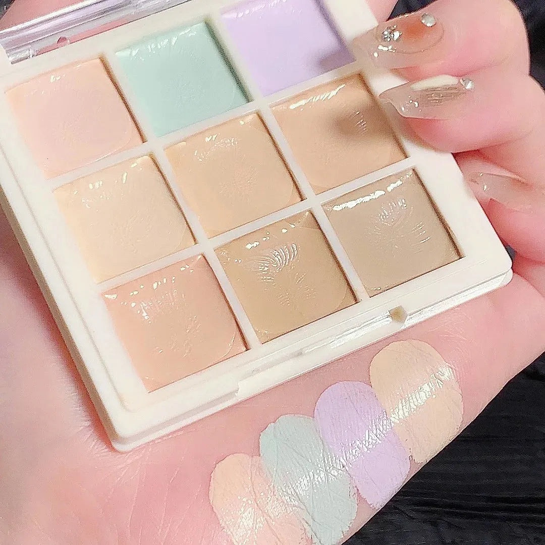 Close-up view of concealer shades being applied to skin with a makeup brush