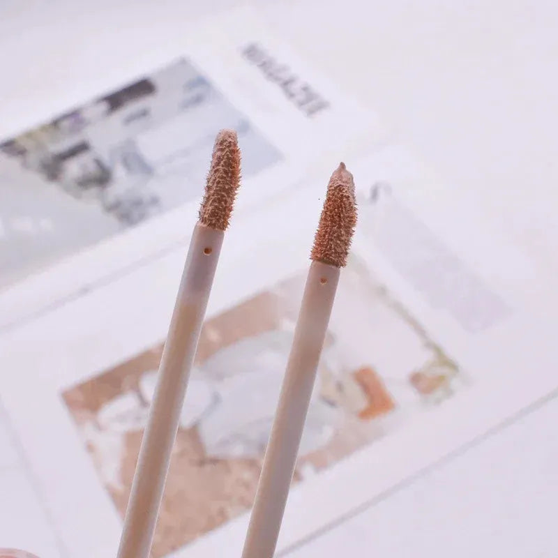 Close-up view of concealer being applied to hand for texture demonstration