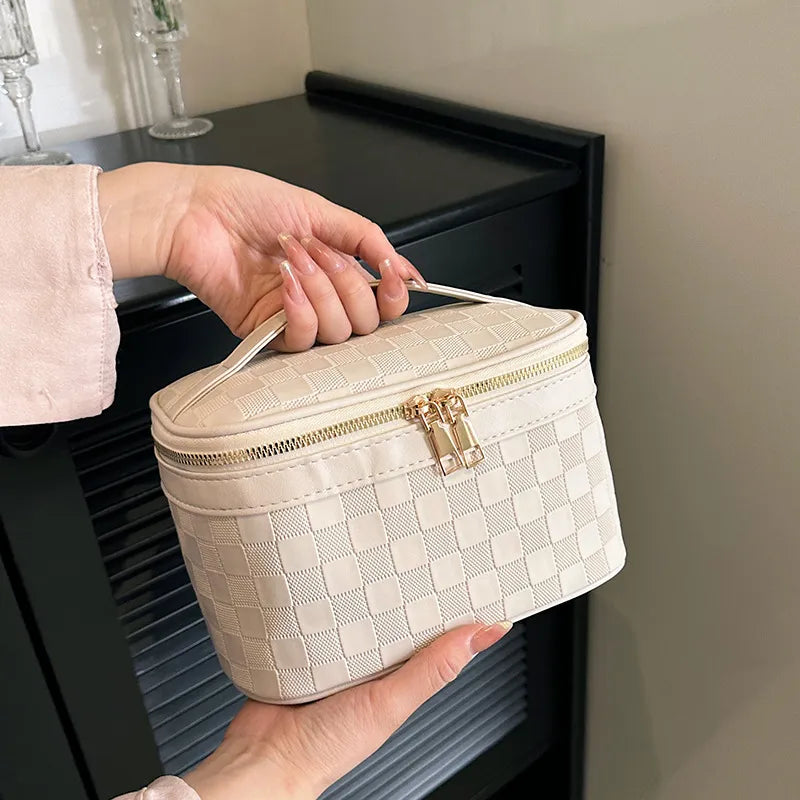 Checkered pattern cosmetic bag with zipper closure