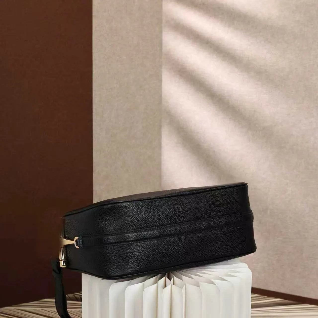 Front view of medium shoulder satchel bag showing structured design
