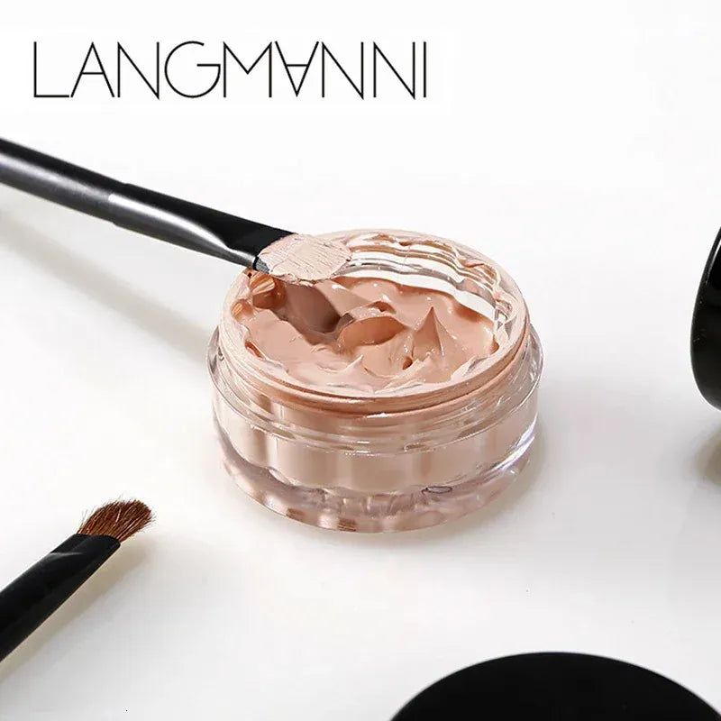 Concealer cream in a compact container with applicator