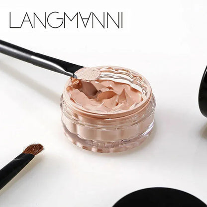 Concealer cream in a compact container with applicator