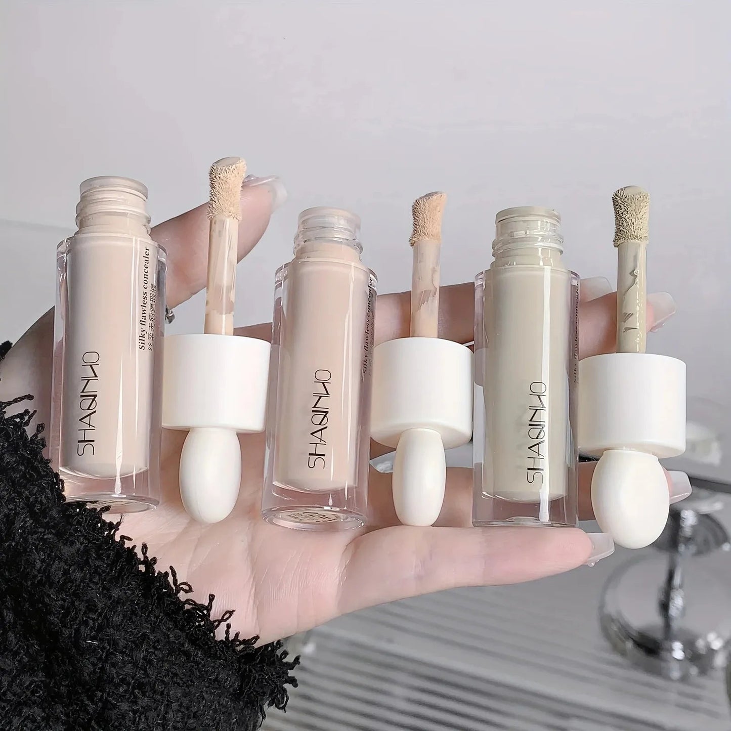 Close-up of concealer being applied to skin to demonstrate coverage