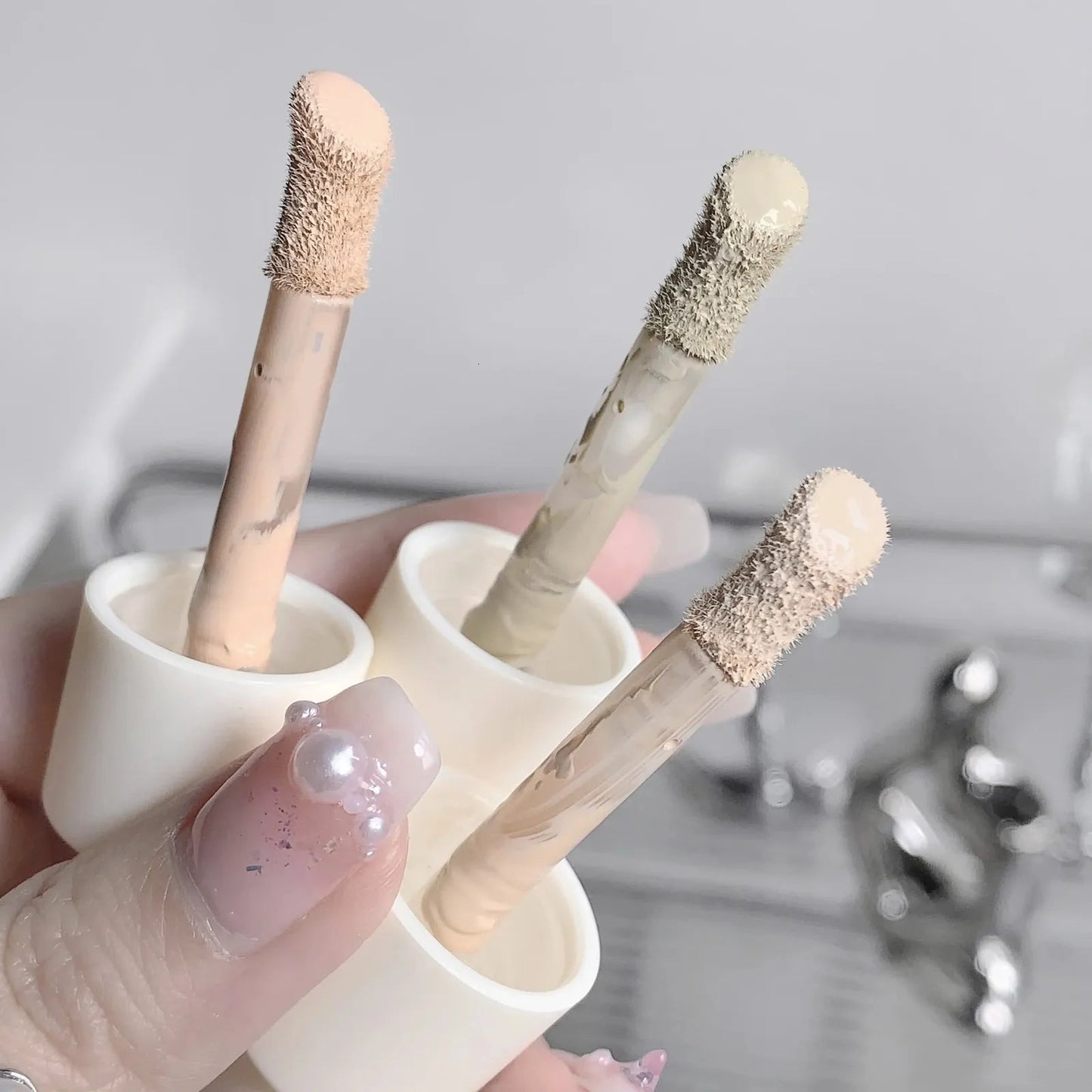 Close-up of concealer being applied to skin to demonstrate coverage