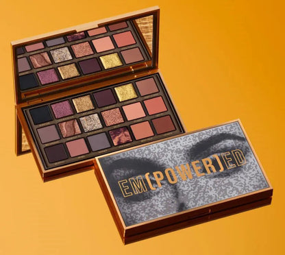 Open eyeshadow palette showing 18 colors in shimmer and matte finishes