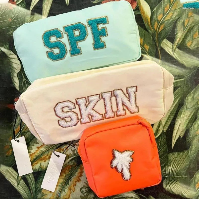 Waterproof nylon cosmetic bag in multiple color options displayed together