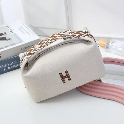 Canvas cosmetics bag with waterproof exterior in lavender color