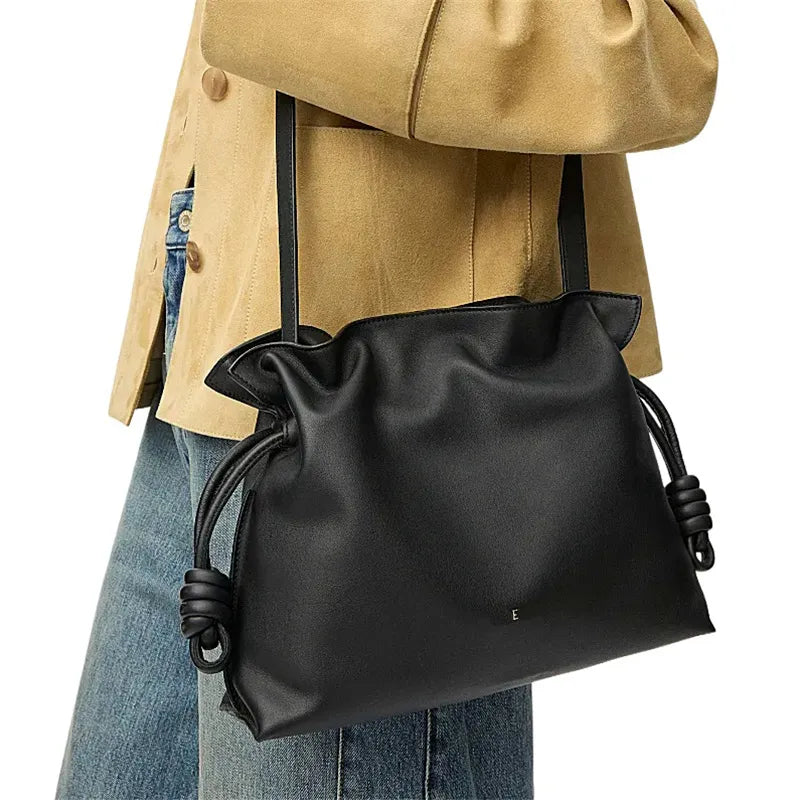 Front view of a leather flamenco clutch bag with chain strap