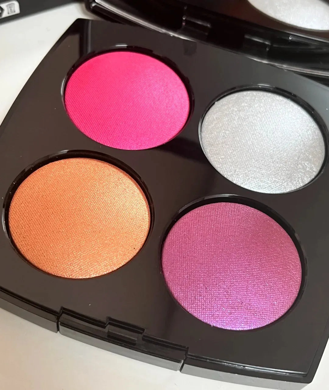 Eye shadow and blush palette with pearl light finish open on a flat surface