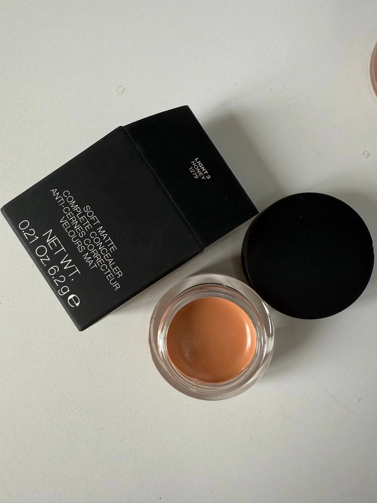 Matte finish concealer cream in a compact container