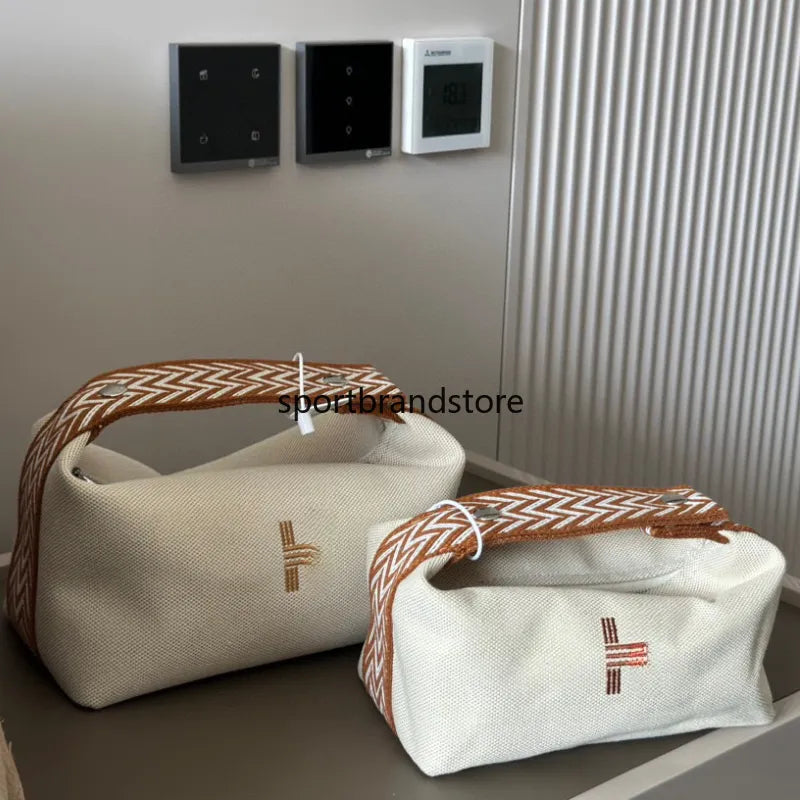 Compact vanity case in lavender color with shoulder strap